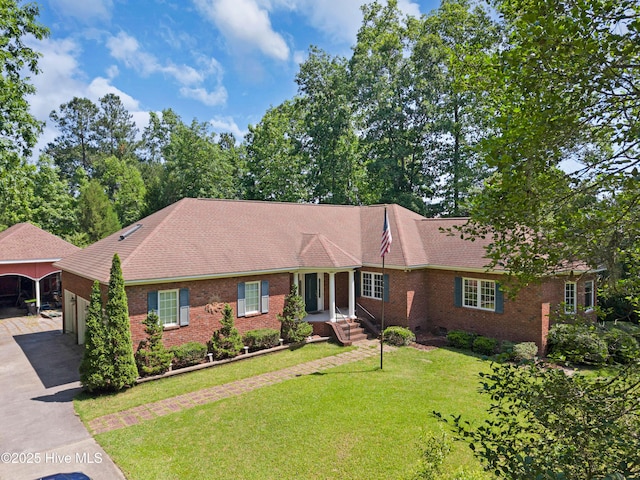 143 Rock Creek Dr, New Bern, NC 28562 - view of front of property with brick siding, a carport, a front lawn, driveway, and a garage