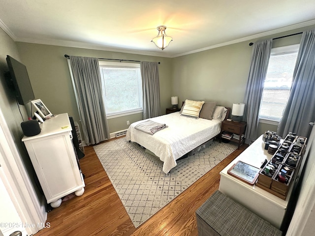 bedroom featuring dark wood finished floors, crown molding, and multiple windows