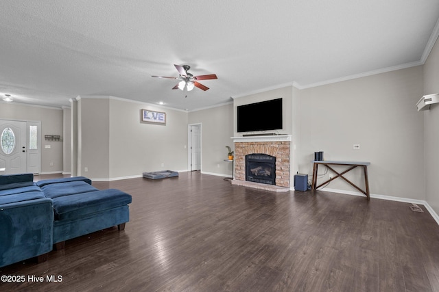 living area featuring ceiling fan, a fireplace with raised hearth, wood finished floors, baseboards, and crown molding