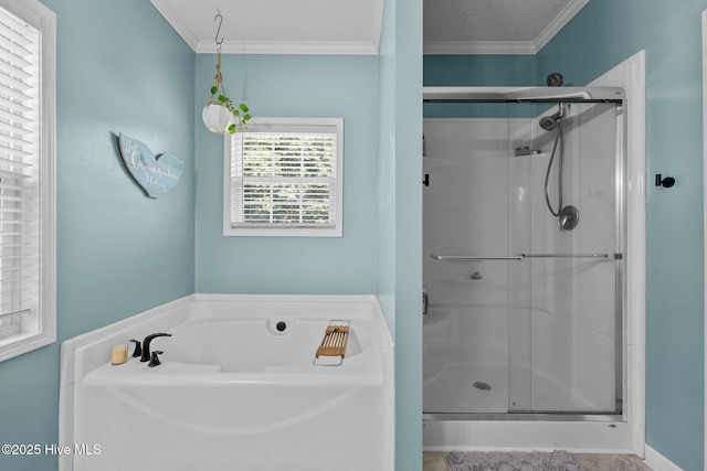 full bathroom featuring a shower stall, crown molding, a garden tub, and a textured ceiling