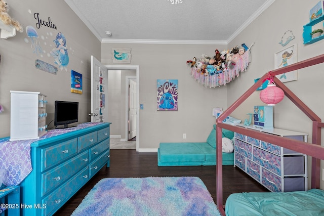 bedroom with wood finished floors, crown molding, a textured ceiling, and baseboards