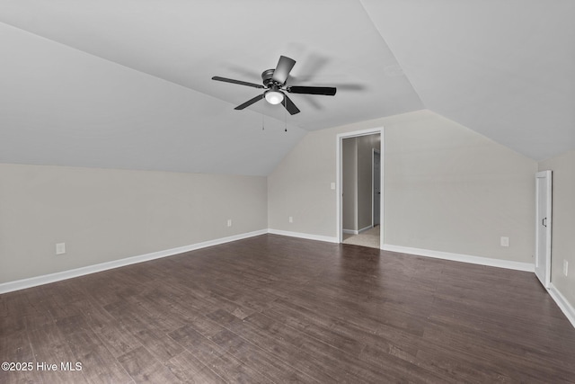 bonus room featuring a ceiling fan, vaulted ceiling, dark wood-style floors, and baseboards