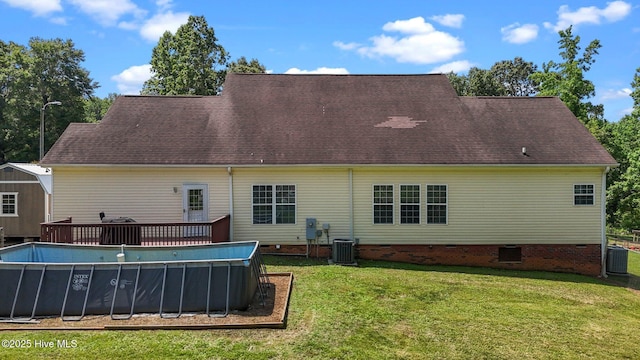 rear view of house with crawl space, central air condition unit, a lawn, and a deck