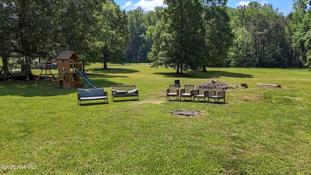 view of property's community featuring a playground and a lawn