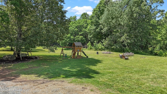 view of green lawn featuring a playground