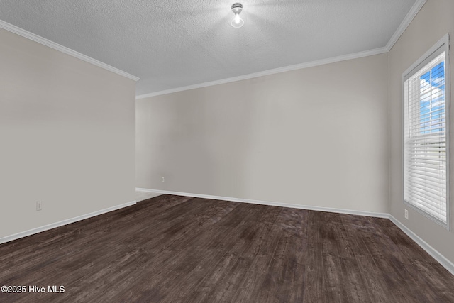 spare room featuring dark wood-style floors, a textured ceiling, baseboards, and crown molding