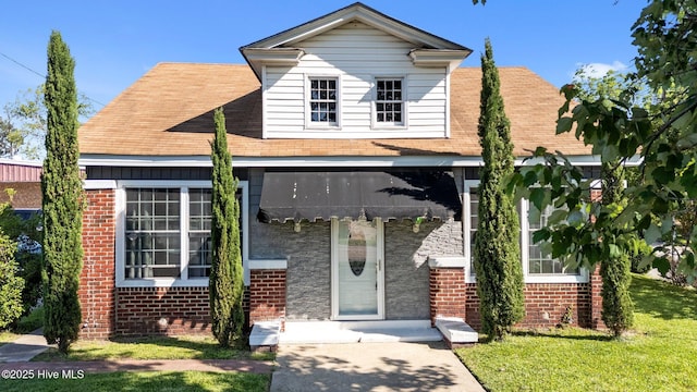 511 Herring Ave NE, Wilson, NC 27893 - view of front of house with brick siding, a front lawn, and a shingled roof