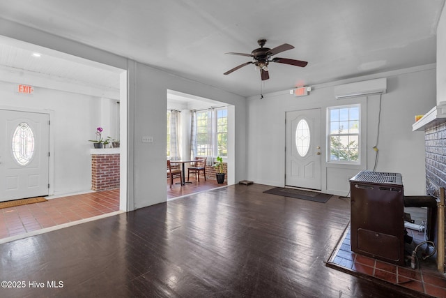 511 Herring Ave NE, Wilson, NC 27893 - foyer entrance featuring a wall mounted AC, a ceiling fan, a fireplace, and wood finished floors