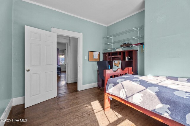 511 Herring Ave NE, Wilson, NC 27893 - bedroom featuring crown molding, wood finished floors, and baseboards