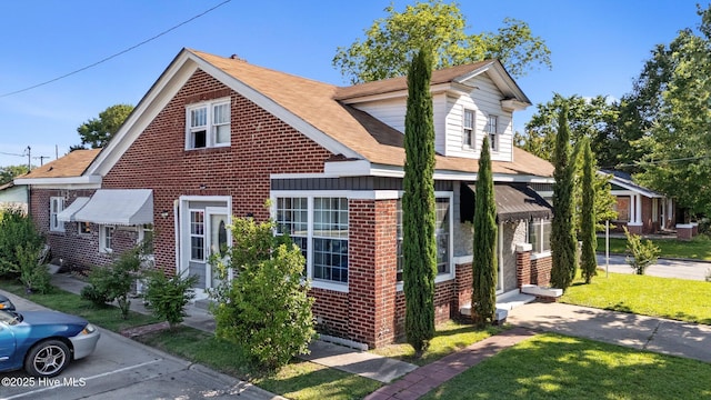 511 Herring Ave NE, Wilson, NC 27893 - view of front facade featuring brick siding, a shingled roof, entry steps, and a front lawn