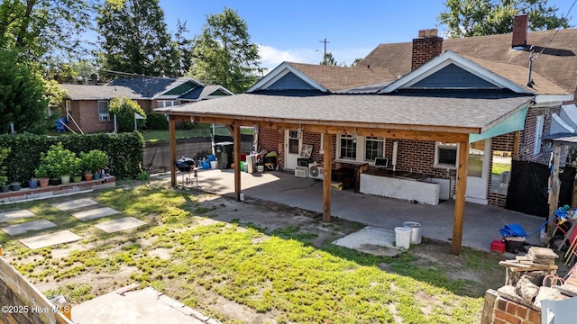 511 Herring Ave NE, Wilson, NC 27893 - back of house featuring roof with shingles, a patio, a fenced backyard, a chimney, and brick siding