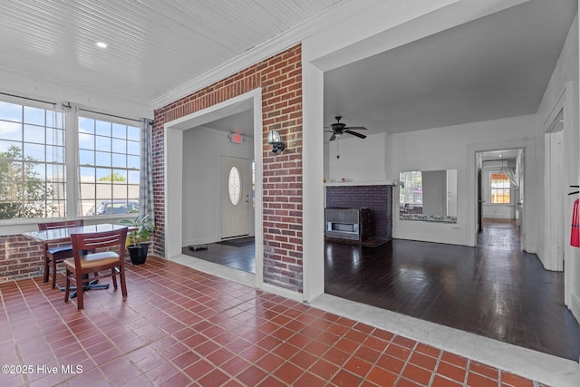 511 Herring Ave NE, Wilson, NC 27893 - living room featuring ceiling fan, a fireplace, healthy amount of natural light, crown molding, and brick wall