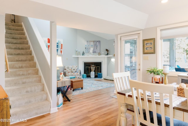 131 Paddle Wheel Cir, Washington, NC 27889 - dining space featuring light wood finished floors, stairs, baseboards, a glass covered fireplace, and recessed lighting