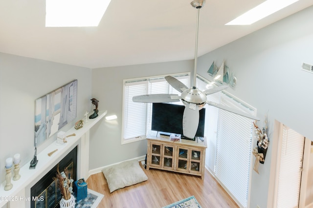 131 Paddle Wheel Cir, Washington, NC 27889 - living area with a fireplace with flush hearth, wood finished floors, baseboards, and a skylight
