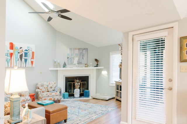 131 Paddle Wheel Cir, Washington, NC 27889 - living area with wood finished floors, vaulted ceiling, ceiling fan, and a fireplace with flush hearth