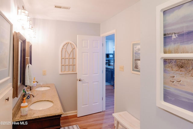 131 Paddle Wheel Cir, Washington, NC 27889 - bathroom with wood finished floors, double vanity, and baseboards