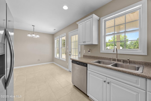 105 E Seabird Ct, Sneads Ferry, NC 28460 - kitchen with appliances with stainless steel finishes, a sink, baseboards, a chandelier, and white cabinets