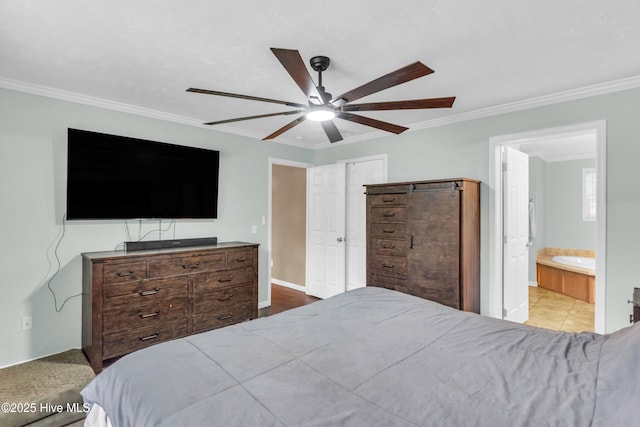 bedroom with crown molding, connected bathroom, and ceiling fan