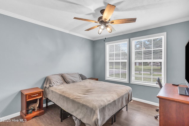 bedroom featuring wood finished floors, baseboards, crown molding, ceiling fan, and a desk