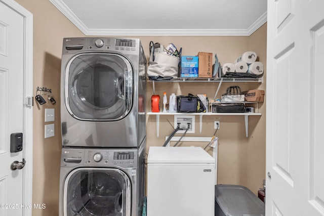 laundry room with stacked washer and clothes dryer and ornamental molding