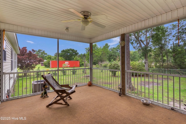 view of patio / terrace featuring ceiling fan and view of scattered trees