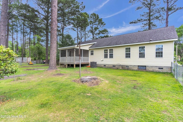 back of property featuring crawl space, a sunroom, a shingled roof, and central AC