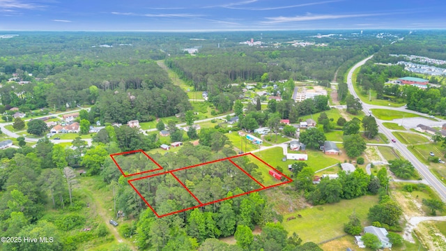 aerial overview of property's location featuring property parcel outlined and a heavily wooded area