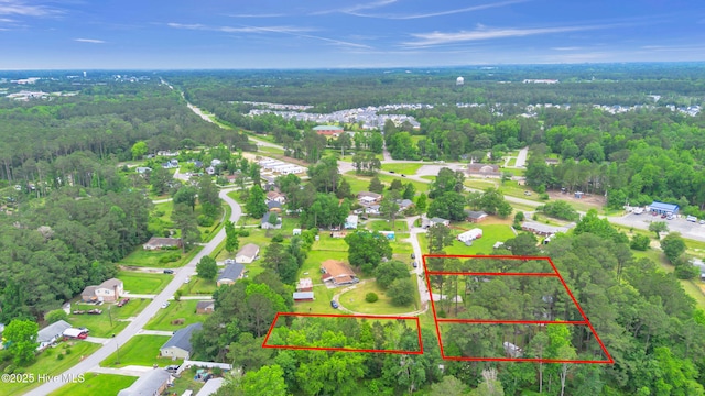aerial overview of property's location with a heavily wooded area and property parcel outlined