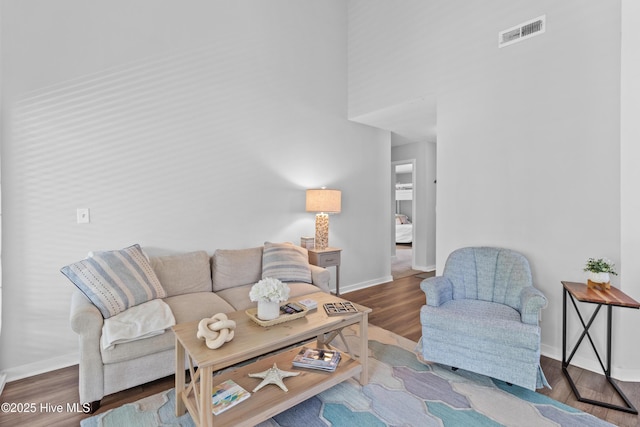 living area with baseboards and wood finished floors