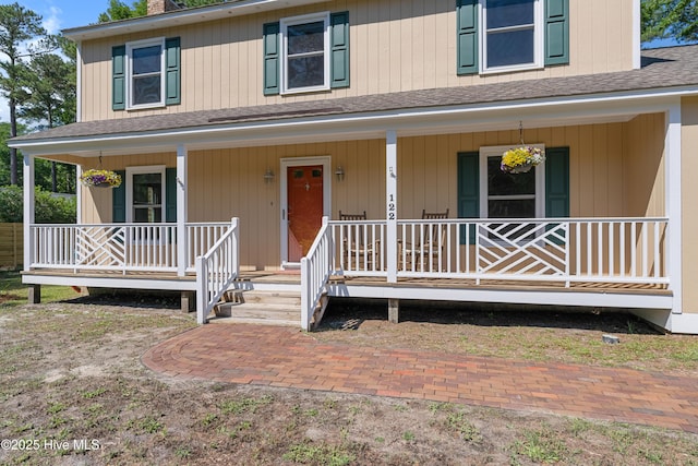 122 Bradley Pines Dr, Wilmington, NC 28403 - view of front of house featuring roof with shingles, covered porch, and a chimney