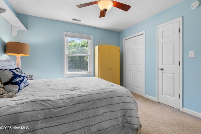 122 Bradley Pines Dr, Wilmington, NC 28403 - bedroom with carpet, a textured ceiling, baseboards, a closet, and a ceiling fan
