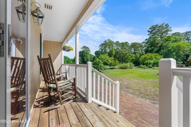 122 Bradley Pines Dr, Wilmington, NC 28403 - wooden terrace with view of wooded area and a yard