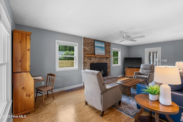 122 Bradley Pines Dr, Wilmington, NC 28403 - living room featuring healthy amount of natural light, light wood-style floors, baseboards, and a brick fireplace
