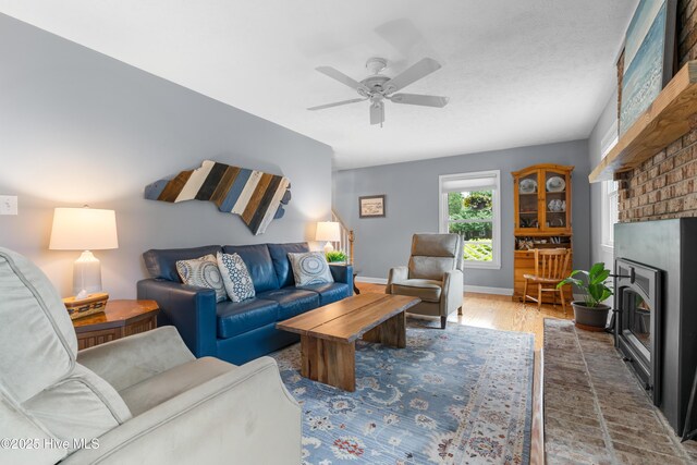 122 Bradley Pines Dr, Wilmington, NC 28403 - living room featuring a brick fireplace, wood finished floors, ceiling fan, and baseboards