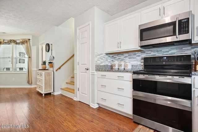 1177 Roberts Rd, Newport, NC 28570 - kitchen featuring stainless steel appliances, decorative backsplash, wood finished floors, a textured ceiling, and white cabinets
