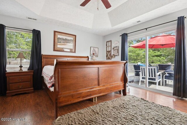1177 Roberts Rd, Newport, NC 28570 - bedroom with access to exterior, a raised ceiling, wood finished floors, a textured ceiling, and ceiling fan