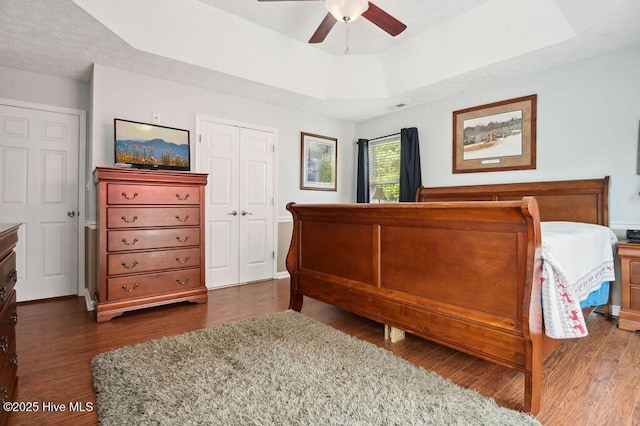1177 Roberts Rd, Newport, NC 28570 - bedroom featuring wood finished floors, a tray ceiling, and ceiling fan