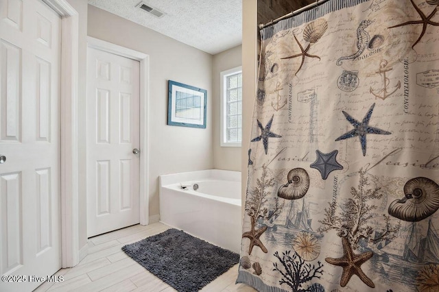 1177 Roberts Rd, Newport, NC 28570 - bathroom with a bath, a textured ceiling, and a shower with curtain
