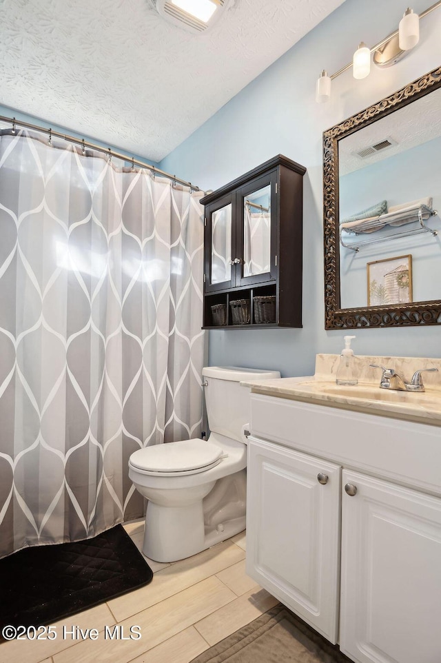 1177 Roberts Rd, Newport, NC 28570 - bathroom with toilet, a textured ceiling, vanity, a shower with shower curtain, and wood finished floors