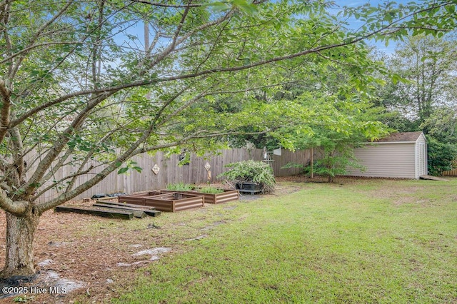 1177 Roberts Rd, Newport, NC 28570 - view of yard featuring a garden, a storage unit, and an outbuilding