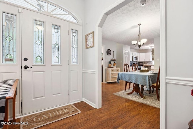 1177 Roberts Rd, Newport, NC 28570 - foyer with a chandelier, dark wood-style flooring, and a textured ceiling