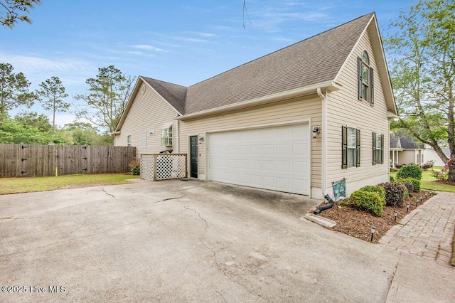 1177 Roberts Rd, Newport, NC 28570 - view of home's exterior featuring concrete driveway, fence, roof with shingles, and a garage