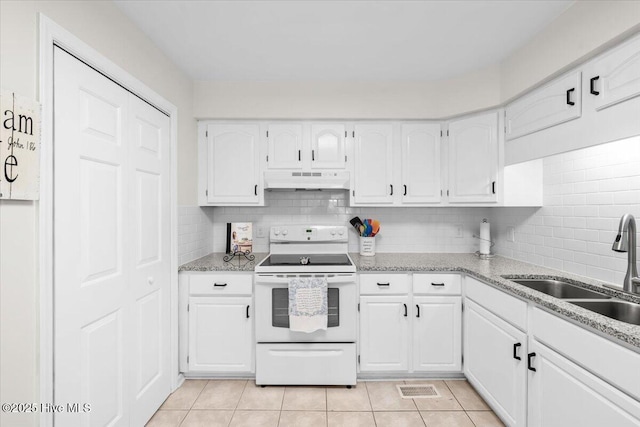 kitchen with white electric range oven, under cabinet range hood, a sink, and white cabinetry