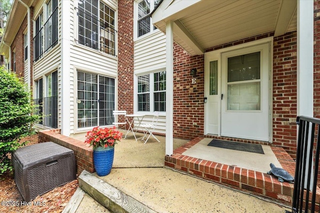 view of exterior entry with brick siding