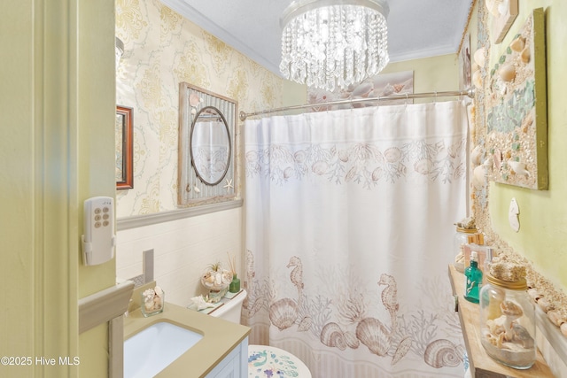 full bathroom featuring crown molding, toilet, tile walls, vanity, and wallpapered walls