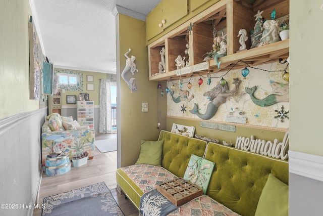 sitting room with wood finished floors and a textured ceiling