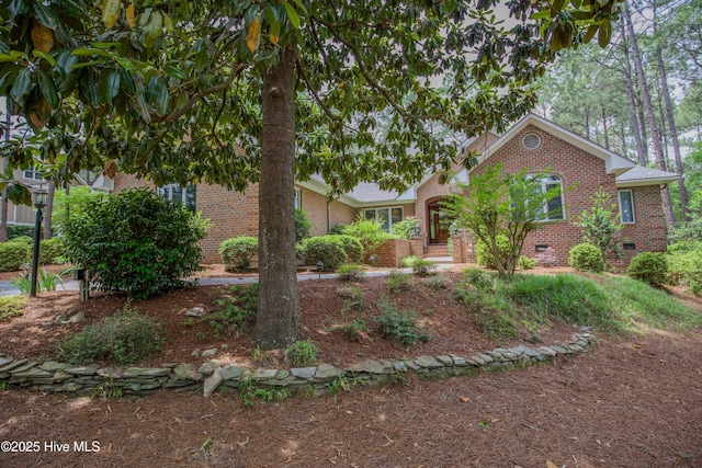 view of front facade featuring brick siding and crawl space