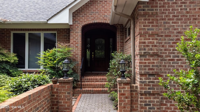 17 Troon Dr, Pinehurst, NC 28374 - view of exterior entry featuring brick siding and roof with shingles