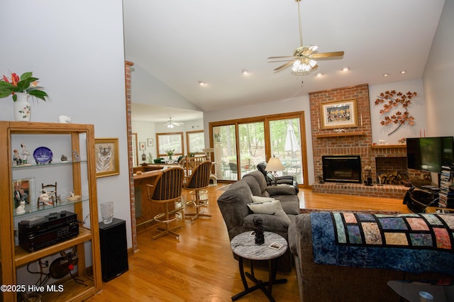 17 Troon Dr, Pinehurst, NC 28374 - living room featuring ceiling fan, vaulted ceiling, light wood finished floors, a brick fireplace, and recessed lighting