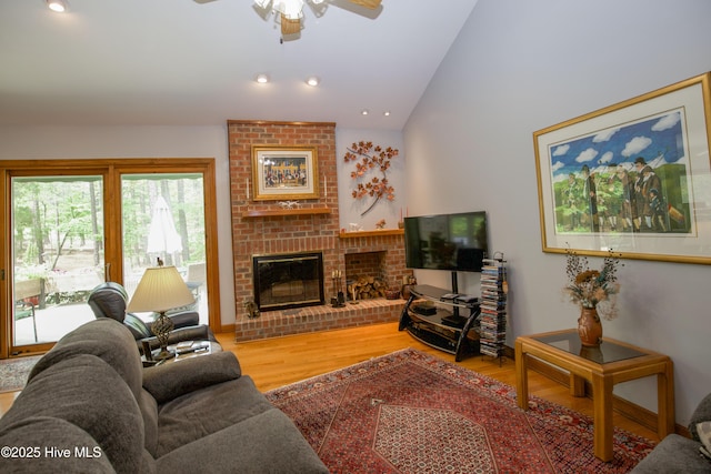 17 Troon Dr, Pinehurst, NC 28374 - living room with lofted ceiling, wood finished floors, a ceiling fan, a brick fireplace, and recessed lighting